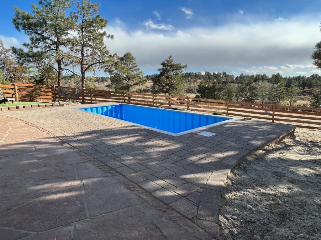 inground container pool with flagstone pool deck denver co